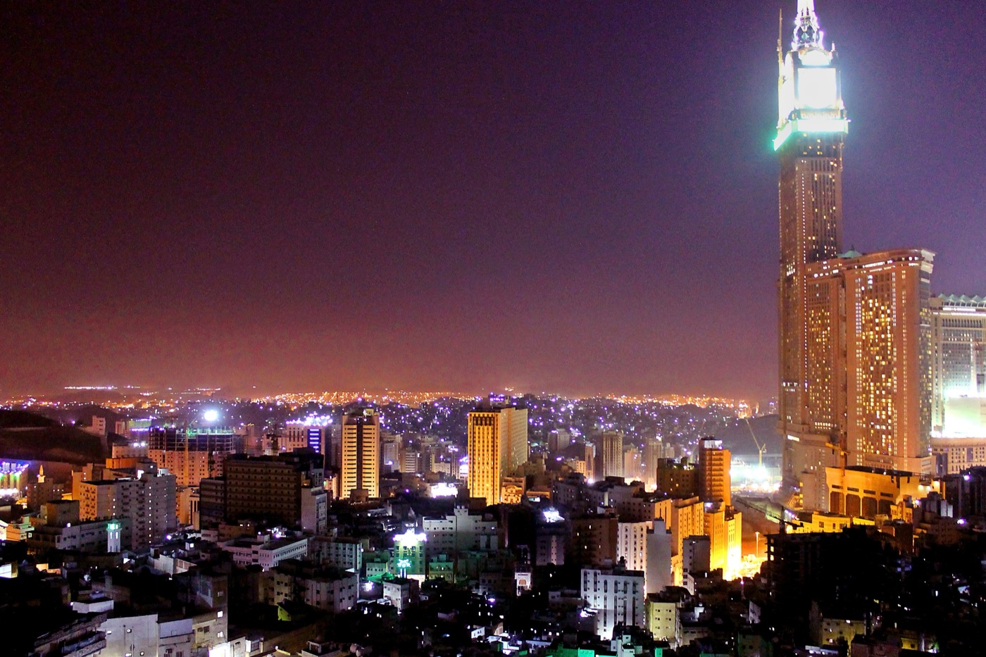 Masjid al-Haram and the surrounding hotel towers illuminated at night in Makkah, Saudi Arabia
